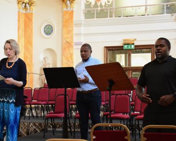 Three soloists on stage, Cerys, Monwabisi and Blaise